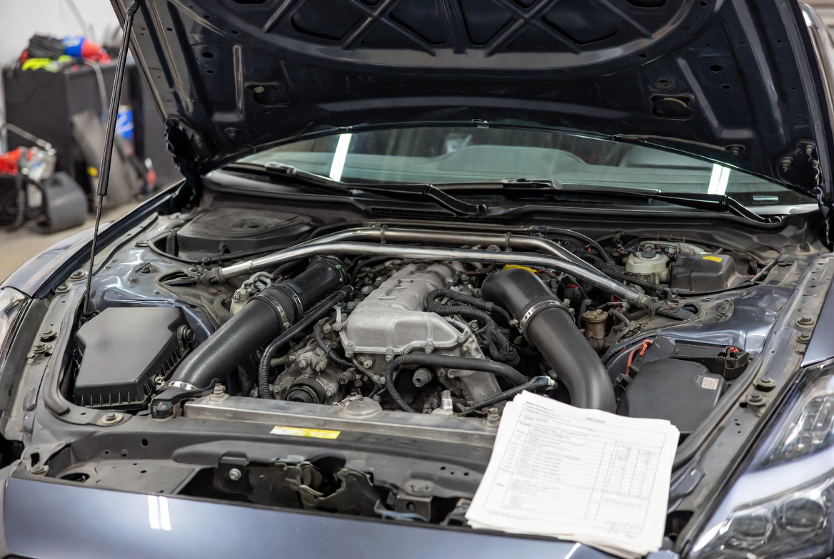 Nissan GT-R parked against the Los Angeles skyline at golden hour dusk